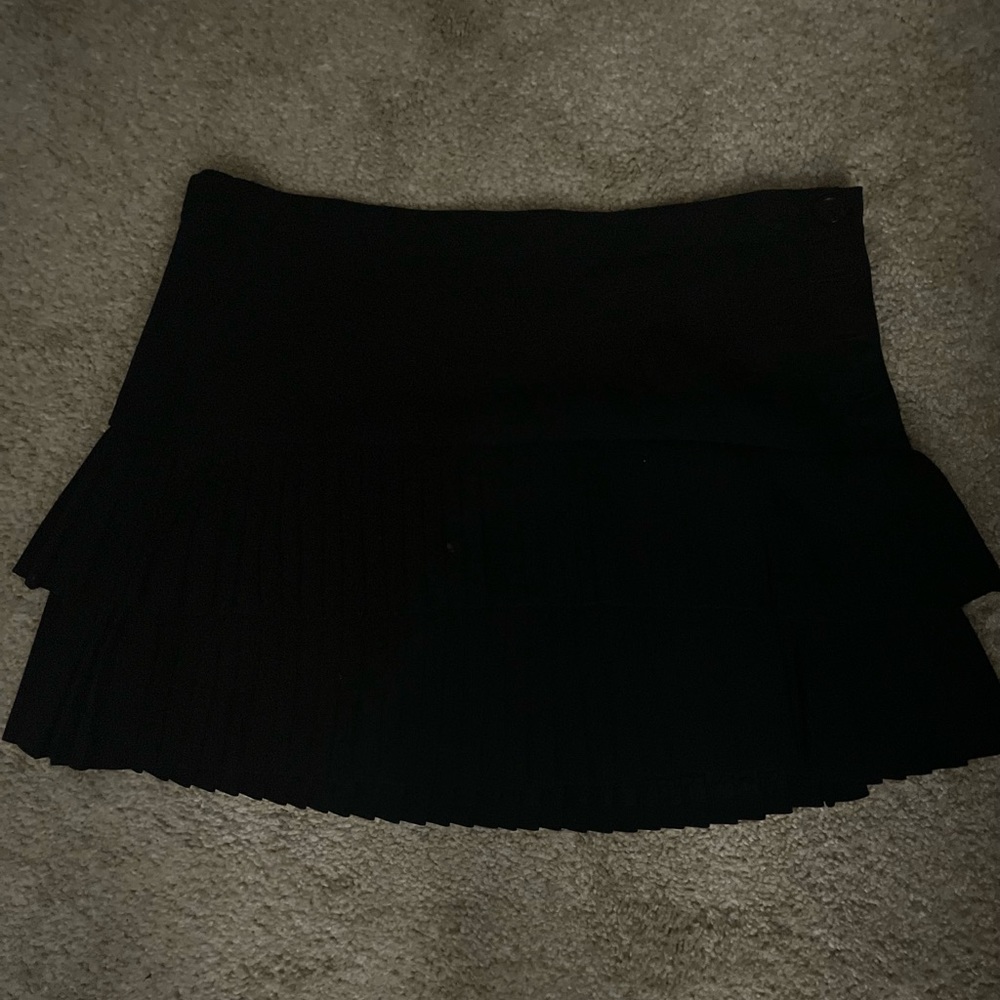 BCBG pleated skirt buttons in the side.